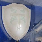 袋に入った盾のパーツ。十字の意匠が入る。