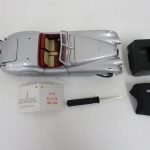本体と付属品。1952 JAGUAR XK 120 の札、ドライバー、黒い部品が並んでいます。