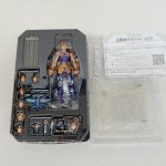ブリスターに収まったフィギュアと付属品、透明な台座と案内用紙