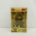 黄色く変色したプラスチックの箱の正面。中に本体とパーツ、下に「BIO FIGHTER COLLECTION APTOM FULL BLAST」の印字。