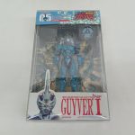 透明なプラスチック箱の正面。中に青緑色の本体、下の台紙に「BIO FIGHTER COLLECTION GUYVER I」の印字。