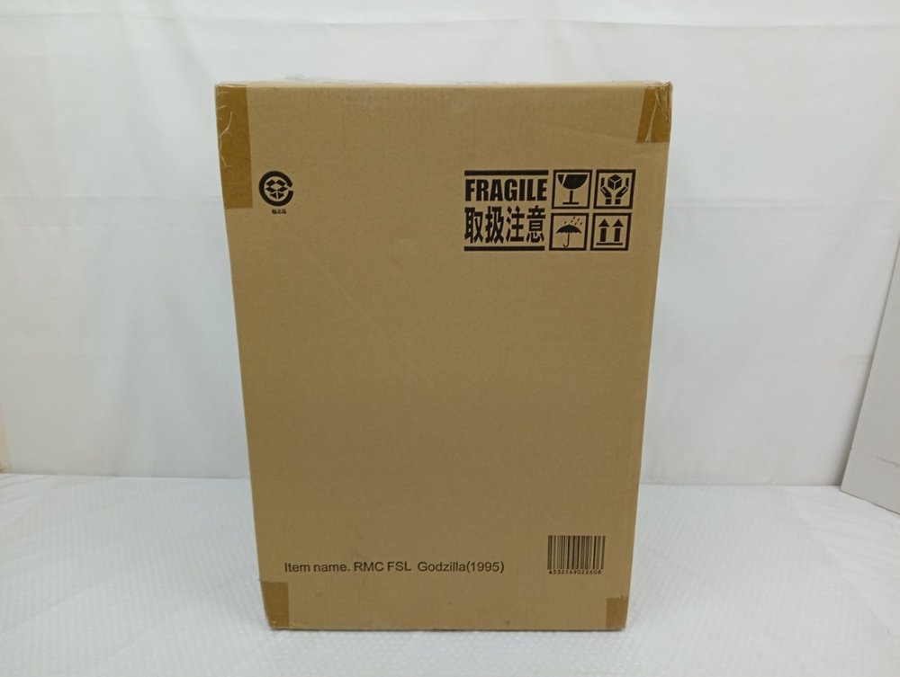 輸送箱の正面。FRAGILE 取扱注意の表示と下部の品名の印字とバーコード