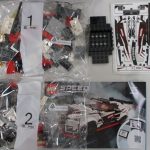 部品の袋2つと、黒い台座の部品、NISSAN のシール、説明書。