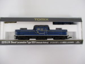 ケースに入った機関車。2215 J.R. Diesel Locomotive Type DD51 と JR北海道色 の印字があります。
