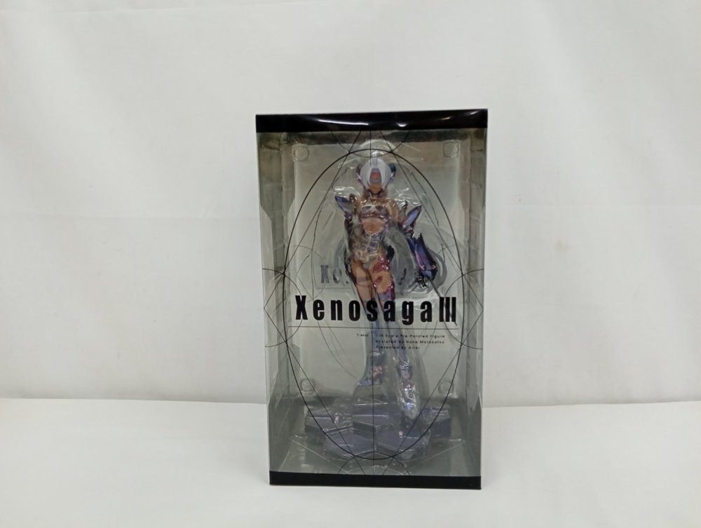 透明の外箱の正面。Xenosaga IIIのロゴと中のT-elosのフィギュア
