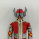 人形の背中の上部。開いたヘルメットと背中のファスナー