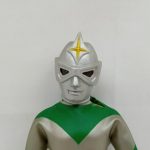 銀色のマスクのアップ。額に黄色い星形の飾り