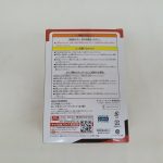 外箱の背面。注意書きと商品名「AMU-PRZ8691 天元突破グレンラガン ぬーどるストッパーフィギュア」、問い合わせ先とQRコード。